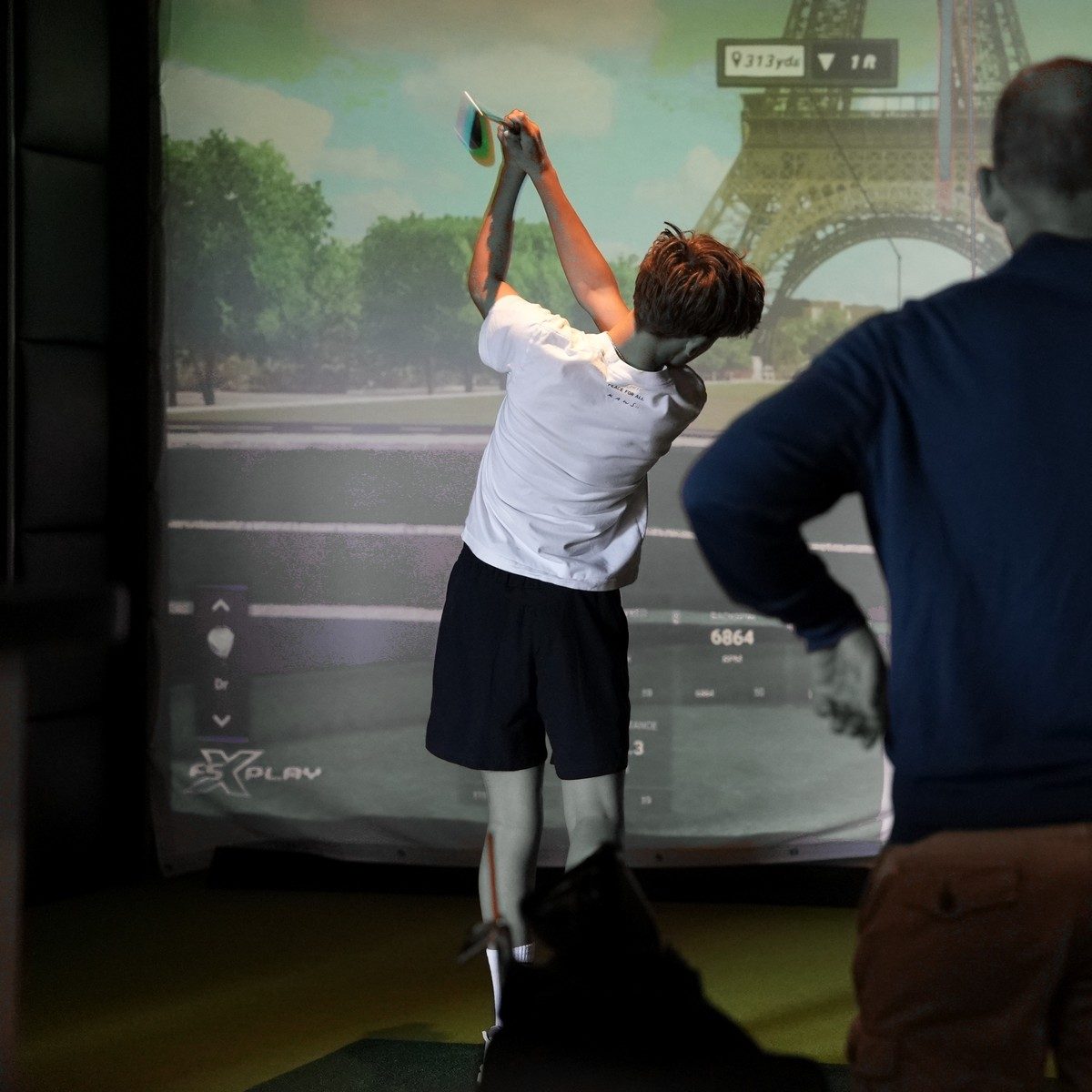 Hitting balls on a Pure Swing simulator bay